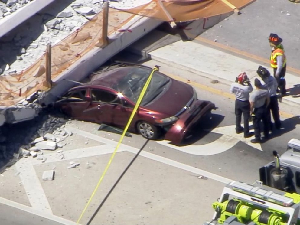 PHOTO: First responders were seen tending to injured victims on the scene of a pedestrian bridge that collapsed on the Florida International University campus.