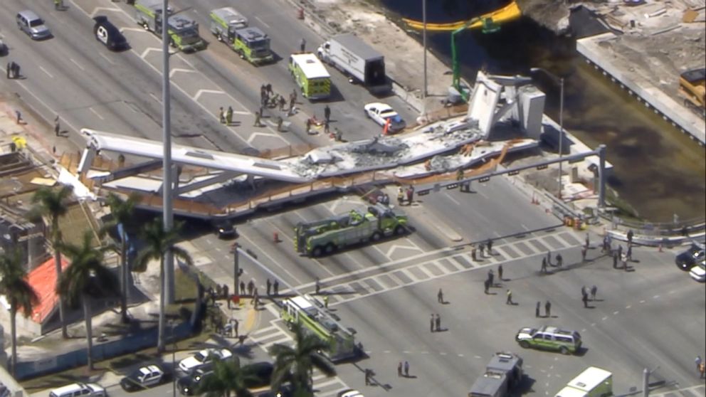 PHOTO: First responders were seen tending to injured victims on the scene of a pedestrian bridge that collapsed on the Florida International University campus. 