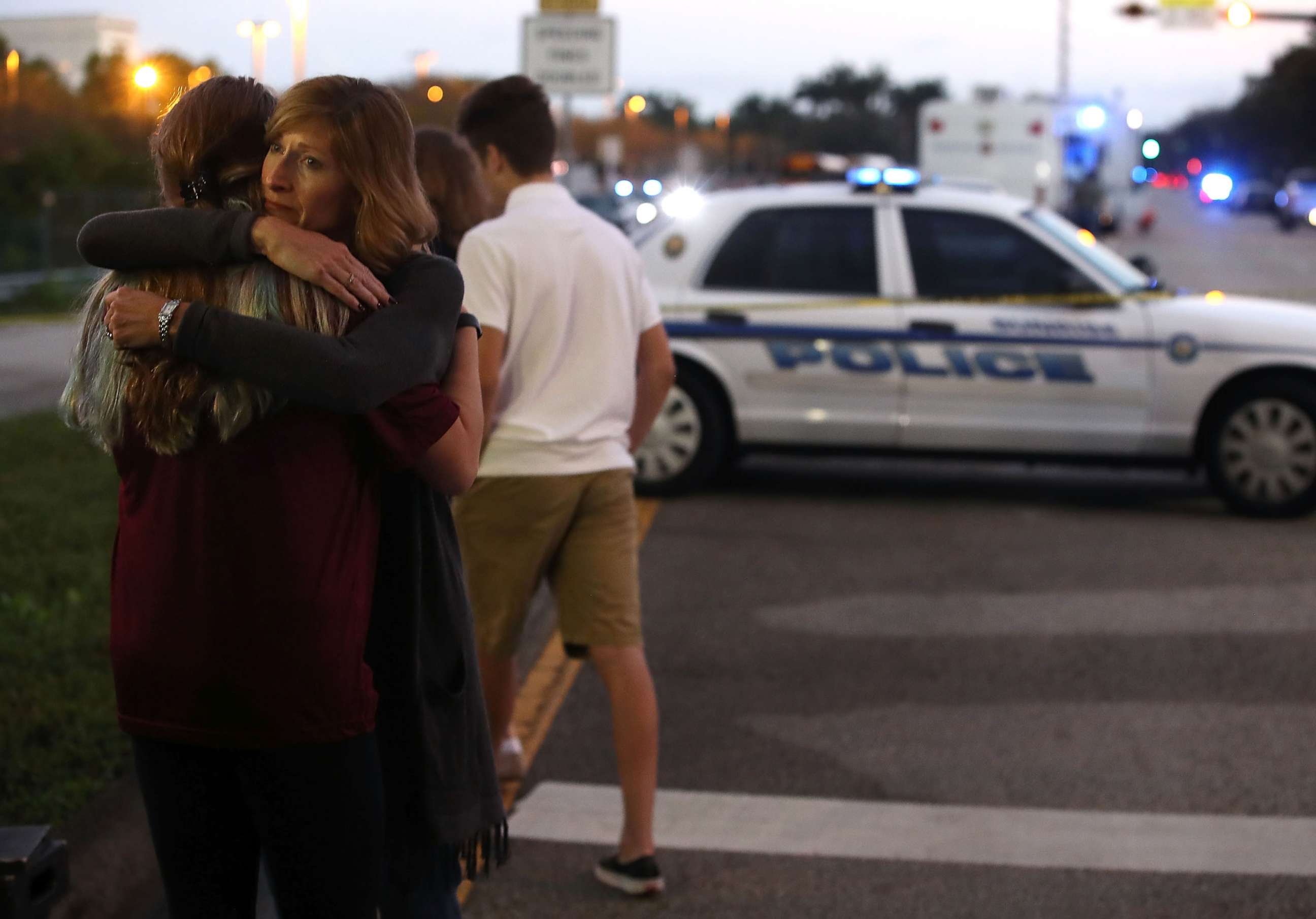 PHOTO: Kristi Gilroy hugs a young woman at a police check point on Feb. 15, 2018, near the Marjory Stoneman Douglas High School in Parkland, Fla., where 17 people were killed by a gunman 