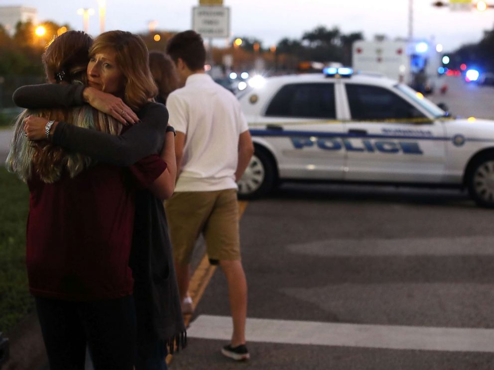 PHOTO: Kristi Gilroy hugs a young woman at a police check point, Feb. 15, 2018, near the Marjory Stoneman Douglas High School where 17 people yesterday were killed by a gunman in Parkland, Fla.