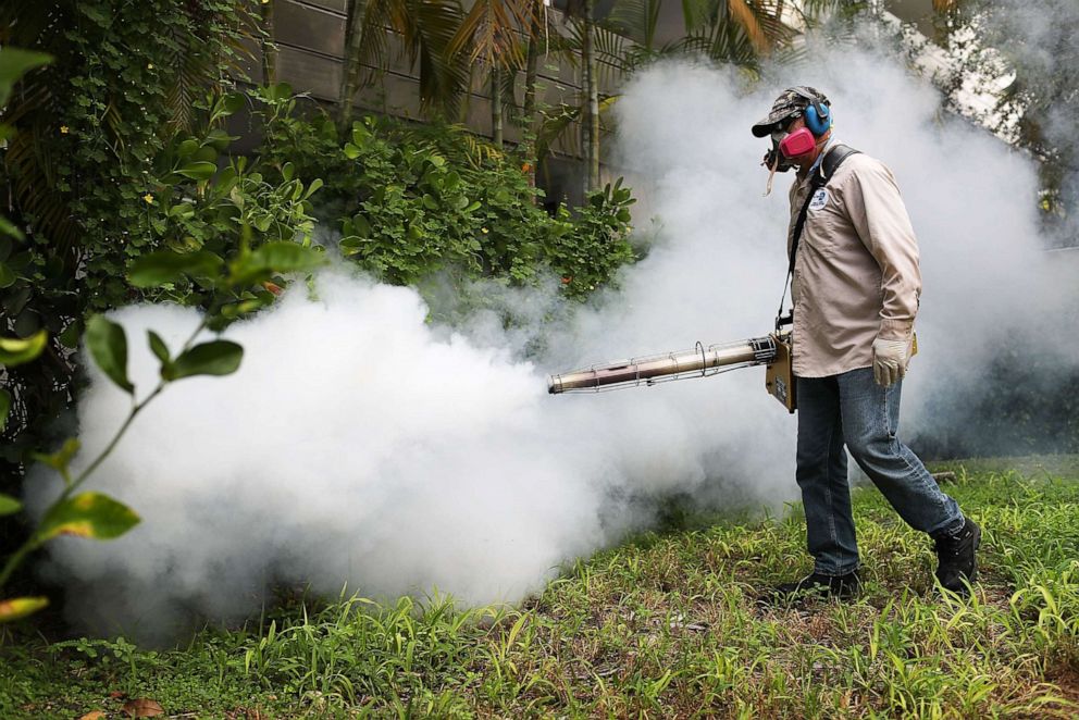 PHOTO: A Miami-Dade County mosquito control inspector sprays pesticide to kill mosquitoes in the Miami Beach neighborhood on Aug. 24, 2016 in Miami Beach, Fla.