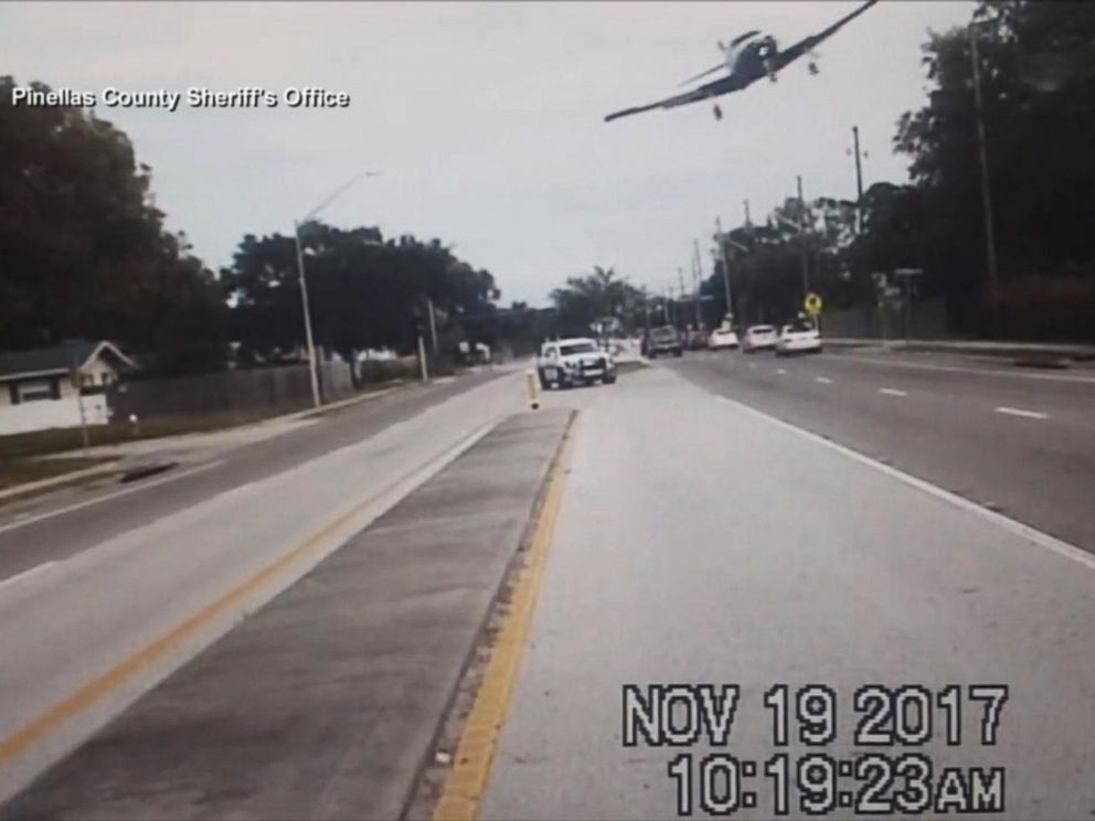 PHOTO: A small plane captured on video by a sheriffs deputy squad car banks over a road before crashing in Clearwater, Fla., Nov. 19, 2017.