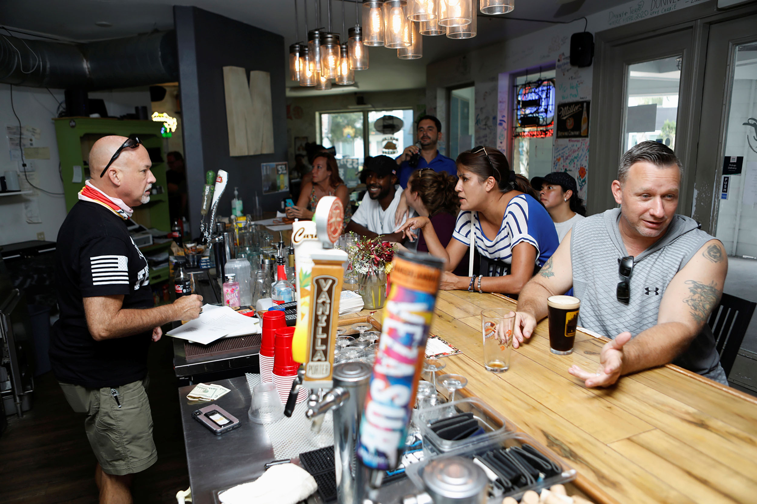 PHOTO: Bar patrons attend the reopen Florida "maskless" rally and dinner held at 33 & Melt restaurant to protest mandatory face mask restrictions during the coronavirus pandemic in Windermere, Fla., July 11, 2020.