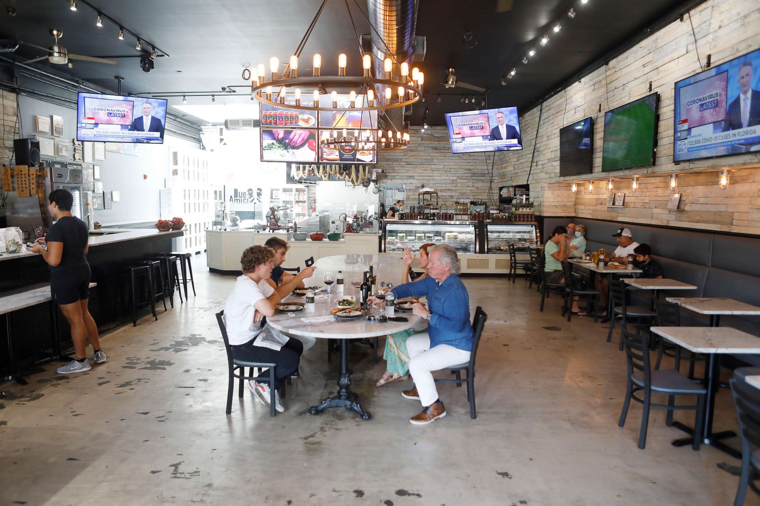 PHOTO: Patrons dine at Due Amici Pizza & Pasta Bar in the Ybor City neighborhood on June 26, 2020, in Tampa, Fla.