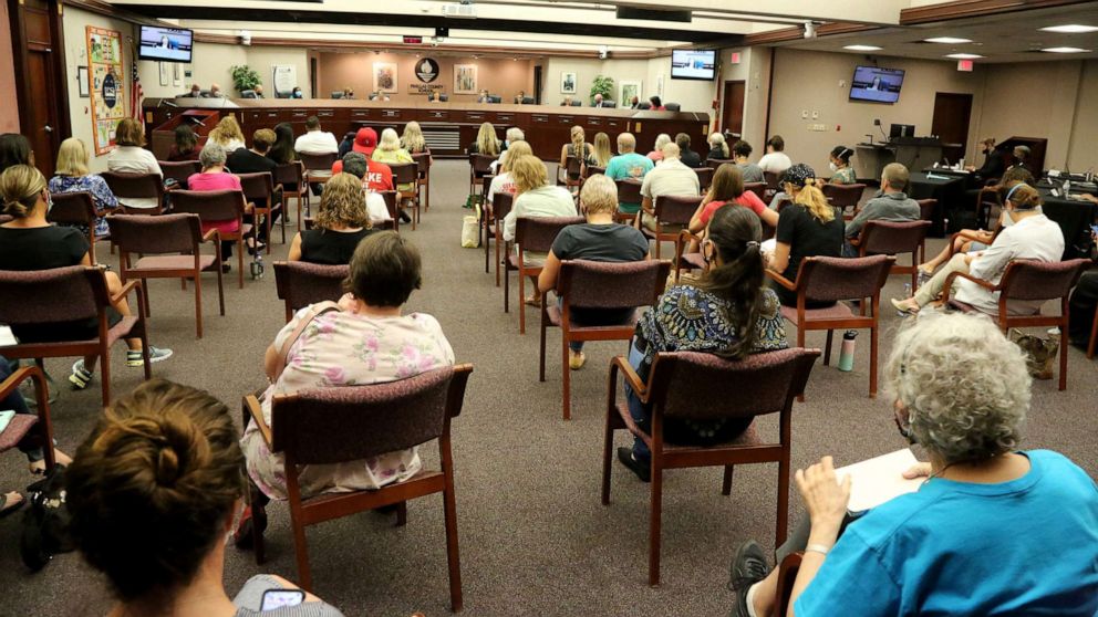 PHOTO: People attend a meeting of the Pinellas County school board, Aug. 24, 2021, in Largo, Fla., where board members made a motion to hold a special meeting to discuss a mask mandate.