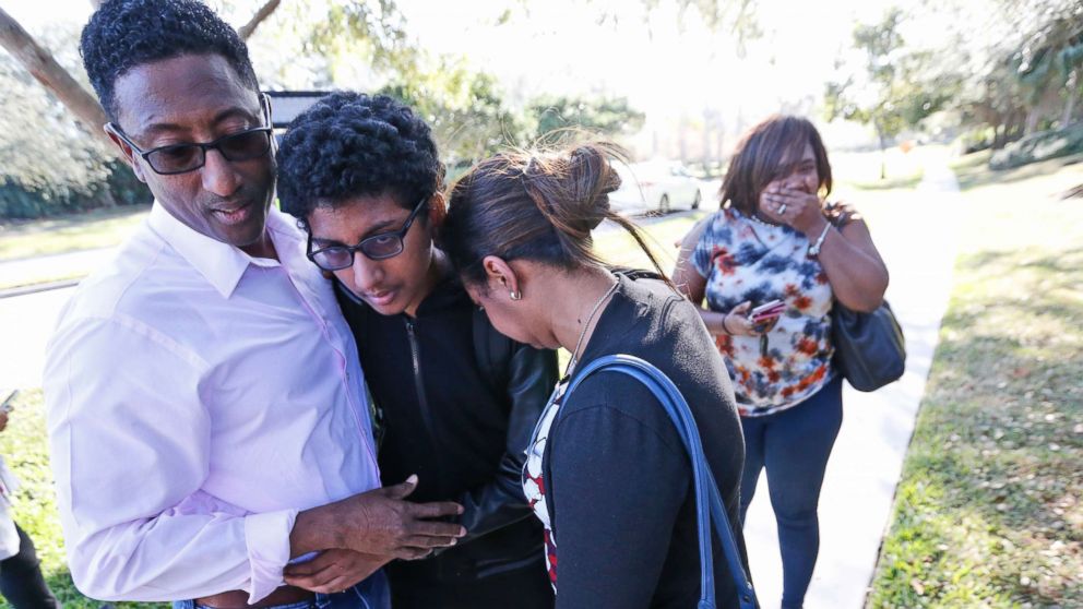 Family members embrace after a student walked out from Marjory Stoneman Douglas High School, Feb. 14, 2018, in Parkland, Fla. 