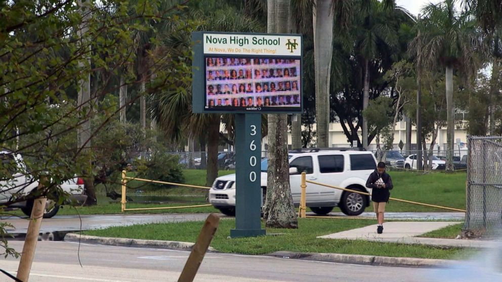 PHOTO: People pass by the entrance to Nova High School in Davie, Fla., Aug. 22, 2019.