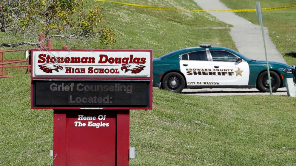 A message about grief counseling appears on the electronic signboard at Marjory Stoneman Douglas High School one day after a shooting at the school left 17 dead in Parkland, Fla. Feb. 15, 2018.