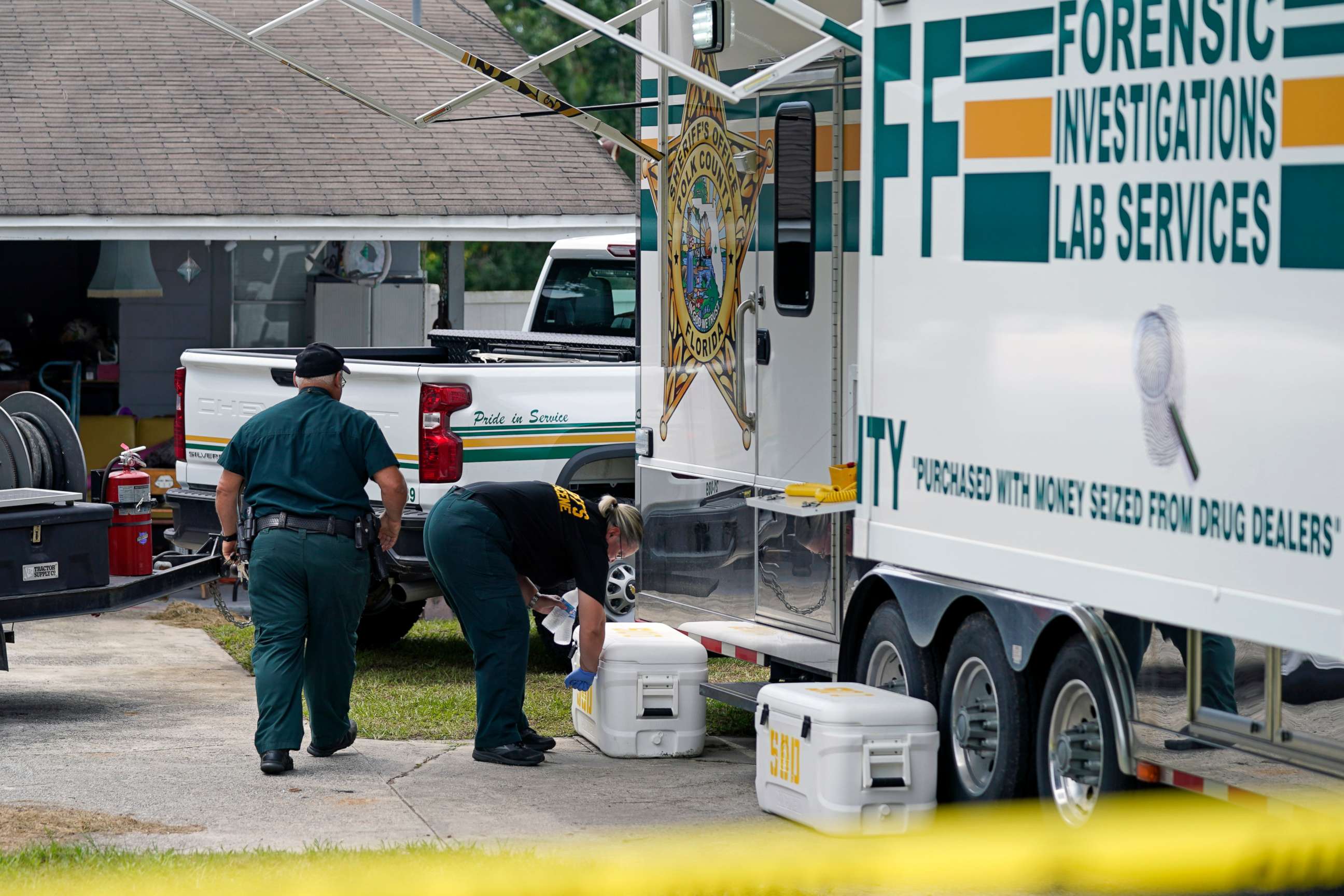 PHOTO: Officers from the Polk County Sheriff Department work outside the home where a family of four was shot and killed, Sept. 7, 2021, in Lakeland, Fla.