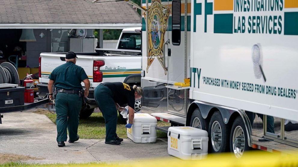 PHOTO: Officers from the Polk County Sheriff Department work outside the home where a family of four was shot and killed, Sept. 7, 2021, in Lakeland, Fla.