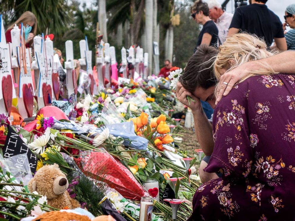 PHOTO: People visit a makeshift memorial in front of the Marjory Stoneman Douglas High School in, Parkland, Florida, Feb. 20, 2018. 