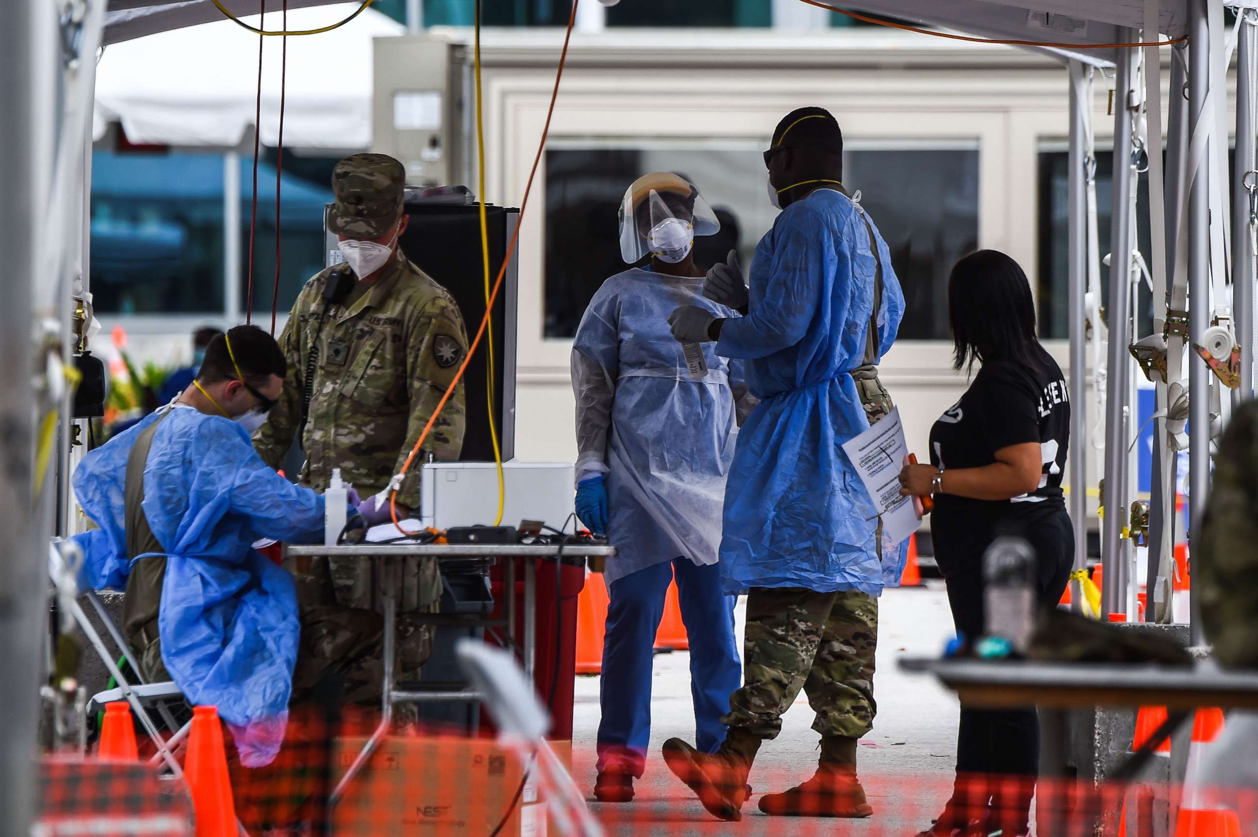 PHOTO: Medical personnel conduct coronavirus testing at a "walk-in" and "drive-through" site in Miami Beach, Fla., July 22, 2020.