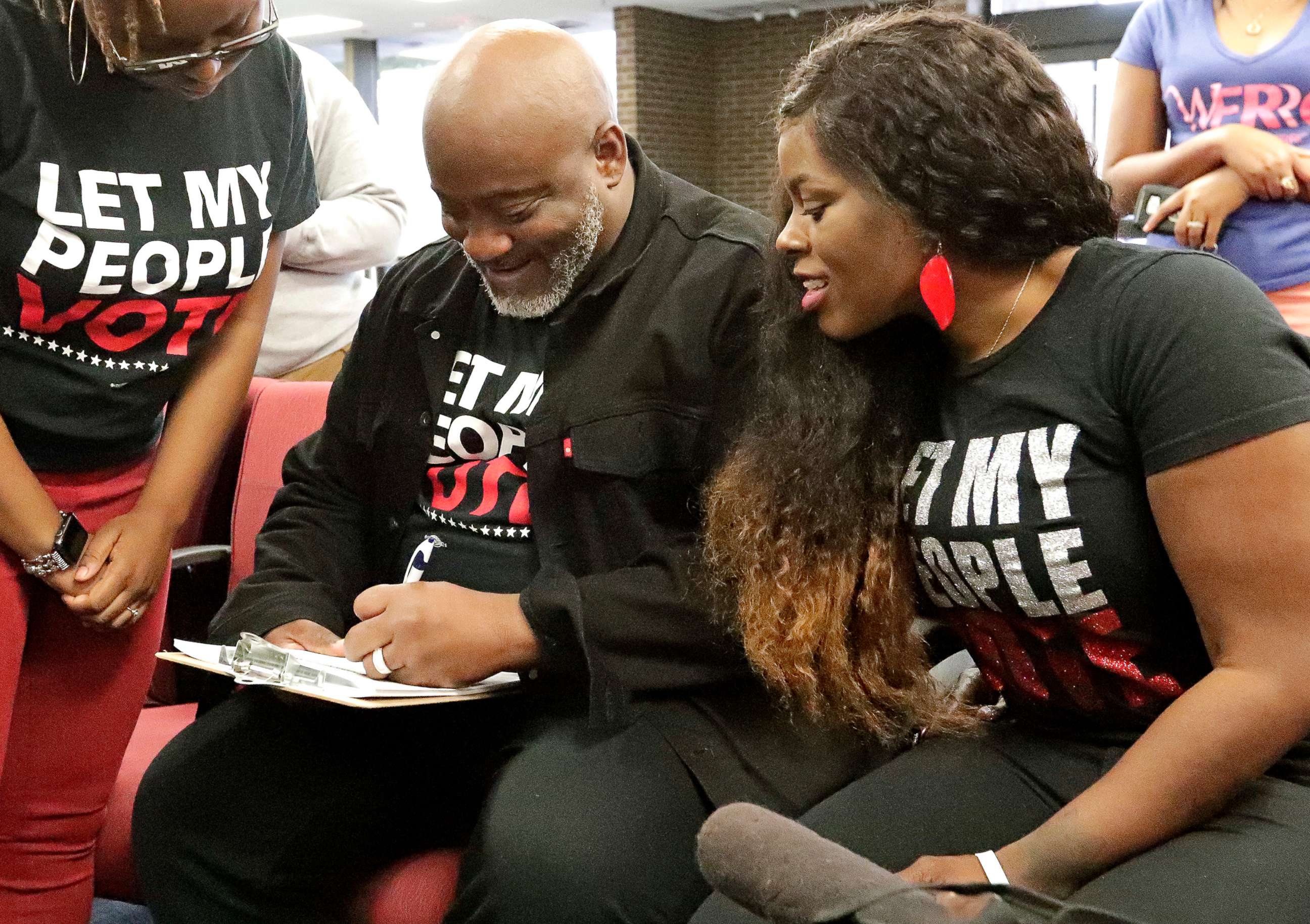 PHOTO: In this Jan. 8, 2019, file photo, former felon Desmond Meade and president of the Florida Rights Restoration Coalition, left, fills out a voter registration form as his wife Sheena looks on at the Supervisor of Elections office in Orlando, Fla.