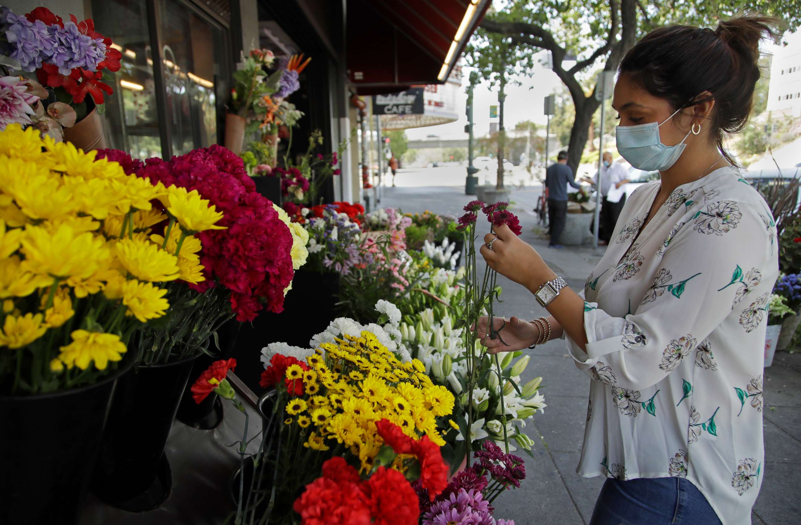 PHOTO: Parisa Hemmat, owner of Grand Flowers, readies her business for opening on Thursday, May 7, 2020, in Oakland, Calif. 