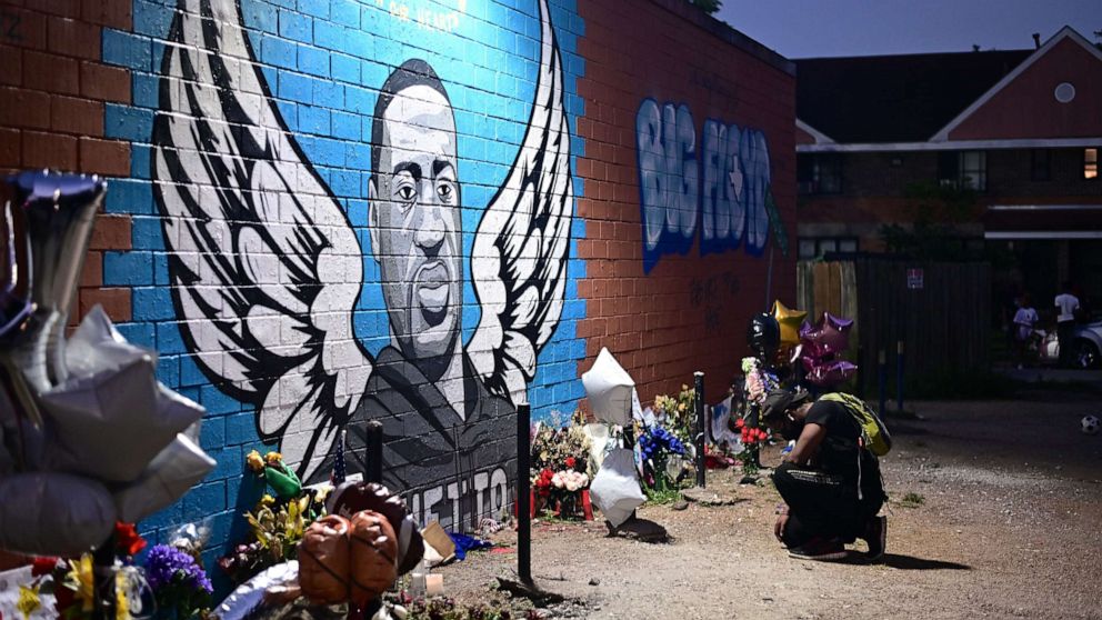 PHOTO: A man pays his respects and kneels in front of a mural of George Floyd in Houston, June 8, 2020. 