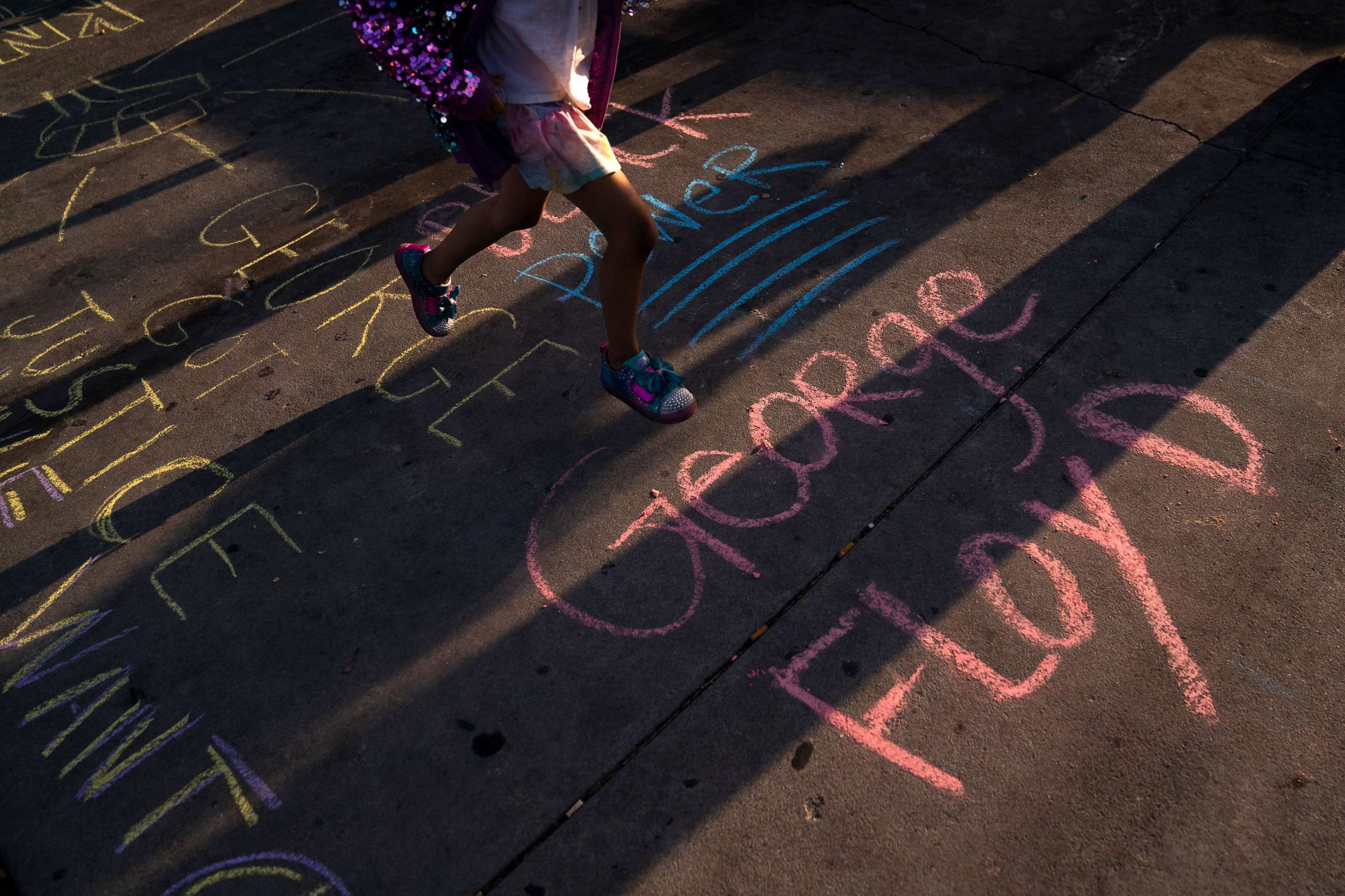 PHOTO: George Floyd's name is written on a sidewalk near the intersection of Florence and Normandie Avenues in Los Angeles, April 20, 2021, after a guilty verdict was announced at the trial of former Minneapolis police Officer Derek Chauvin.