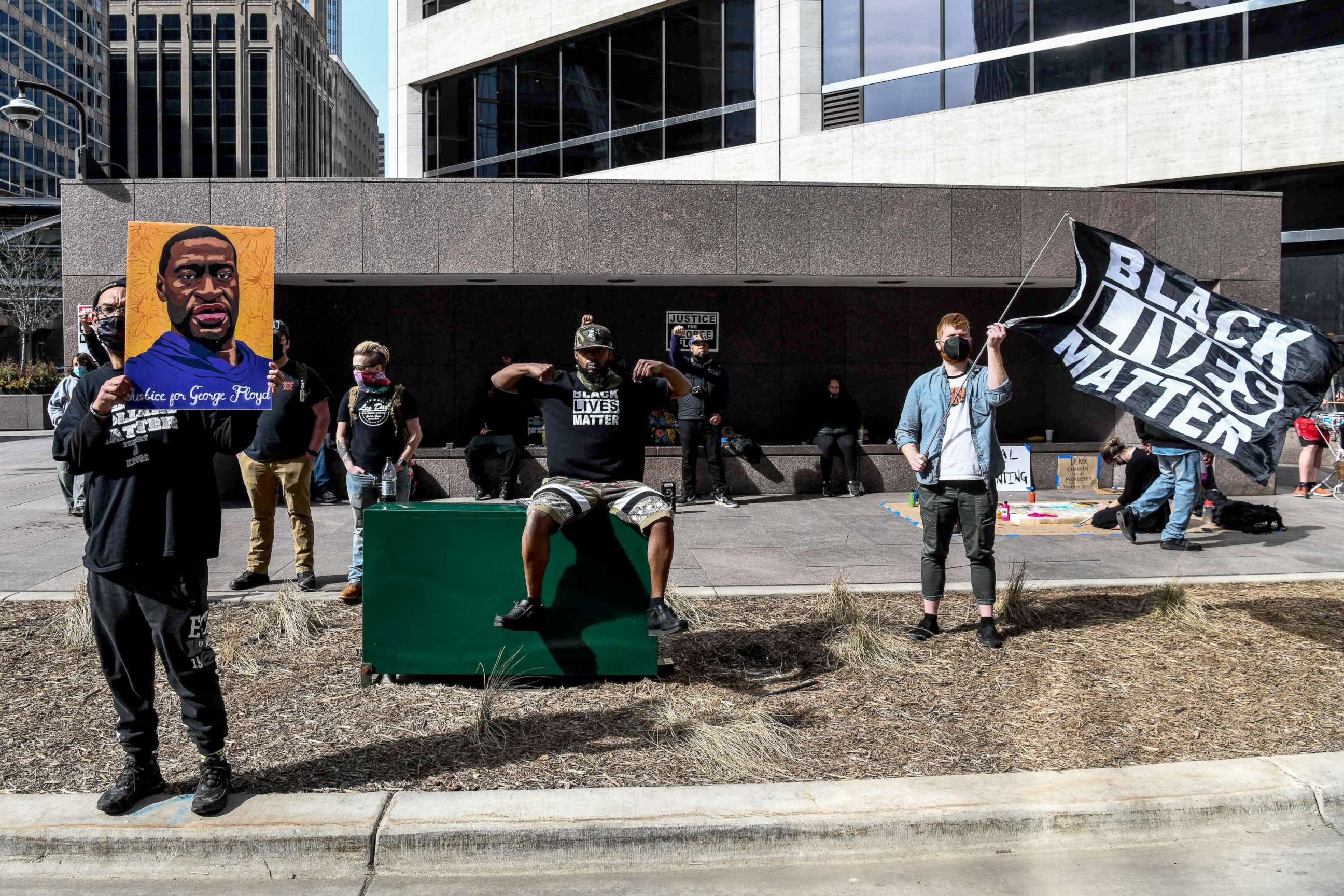 PHOTO: A demonstrator holds a portrait of George Floyd outside the Hennepin County Government Center, March 9, 2021, in Minneapolis, Minnesota.
