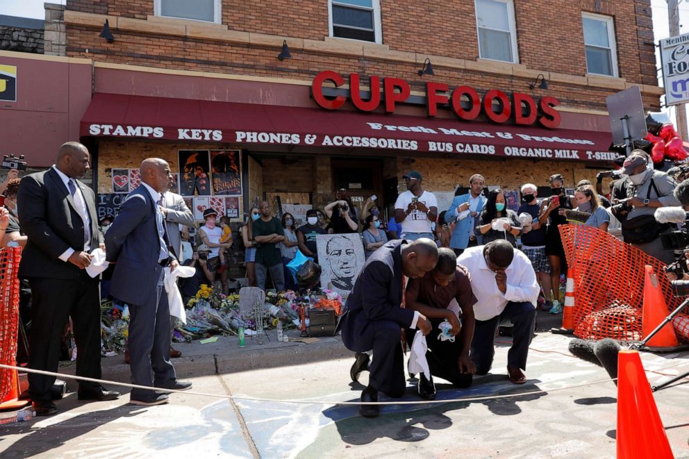 PHOTO: Civil rights attorney Ben Crump and George Floyd's son, Quincy Mason Floyd, react as they visit the site where George Floyd was taken into police custody, in Minneapolis, June 3, 2020.