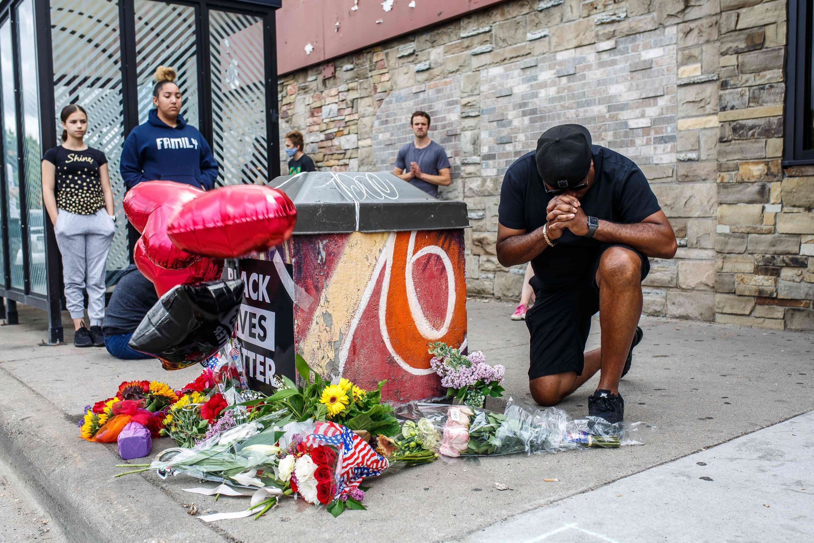 PHOTO: A protester prays in front of the memorial of George Floyd who died in custody on May 26, 2020 in Minneapolis.