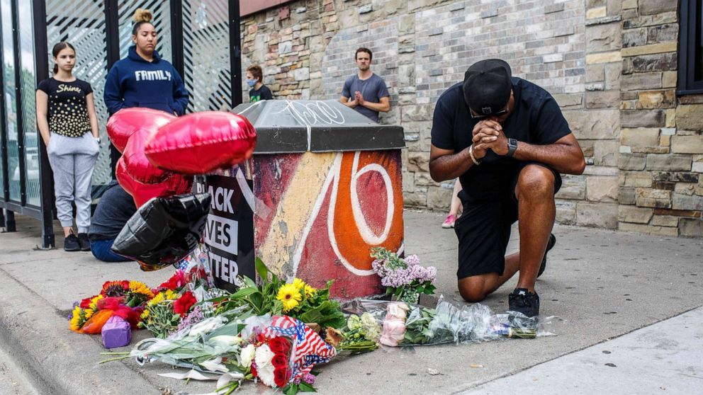 PHOTO: A protester prays in front of the memorial of George Floyd who died in custody on May 26, 2020 in Minneapolis.