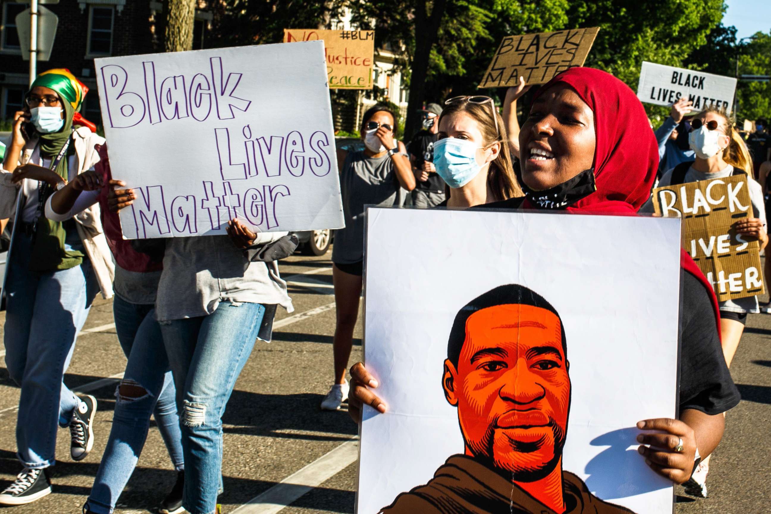PHOTO: People hold signs and protest against the death of George Floyd, June 5, 2020 in Minneapolis, Minnesota.