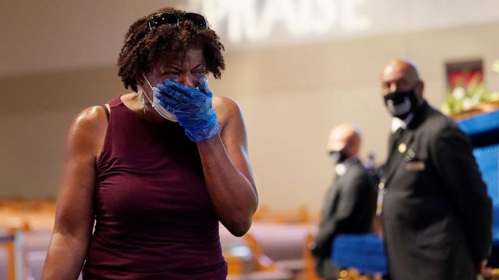 PHOTO: Mourner Charlene Thompson, of Houston, passes by the casket of George Floyd during a public visitation for Floyd at the Fountain of Praise church, June 8, 2020, in Houston. 