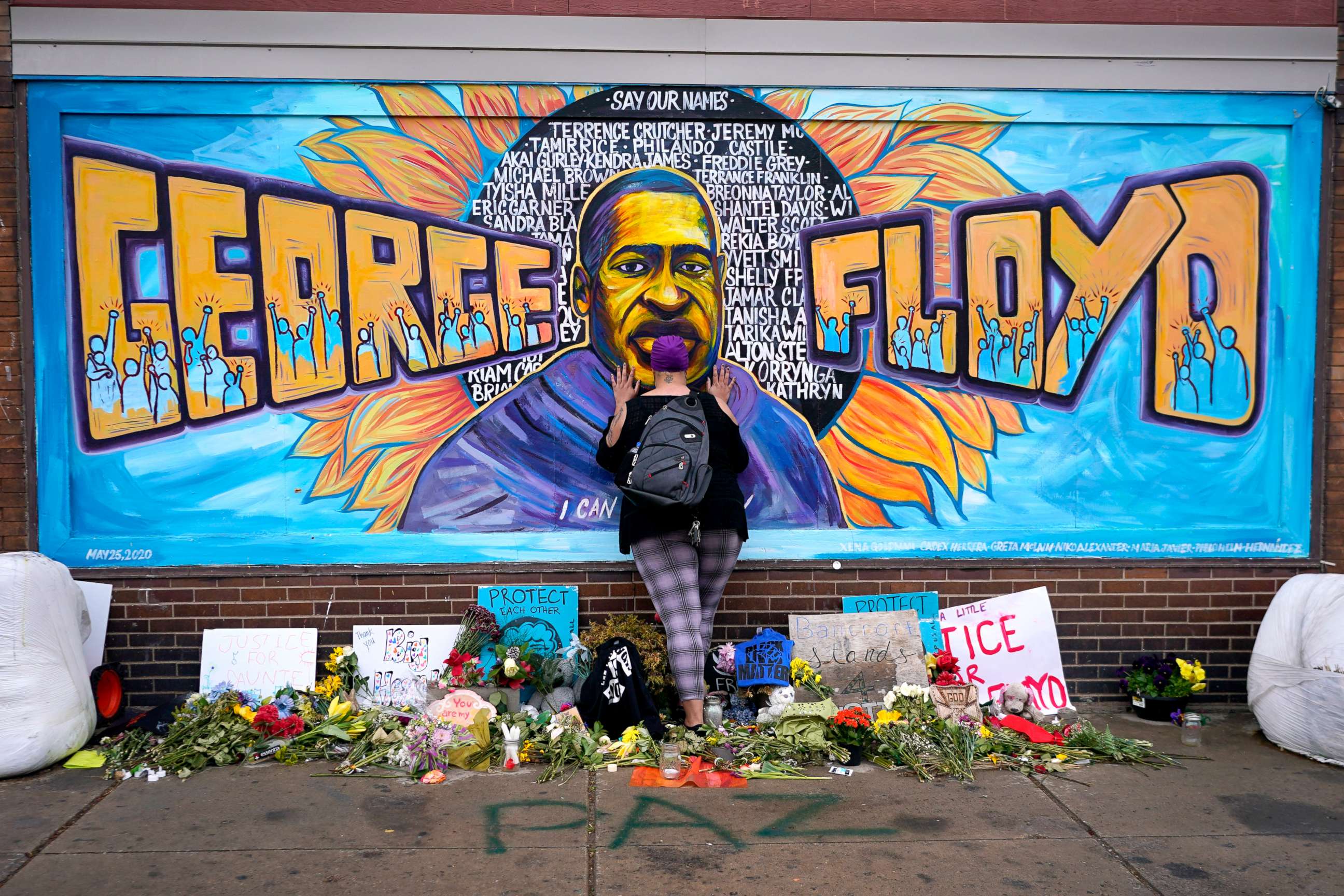 PHOTO: People pays respect to George Floyd at a mural at George Floyd Square in Minneapolis, April 23, 20211.