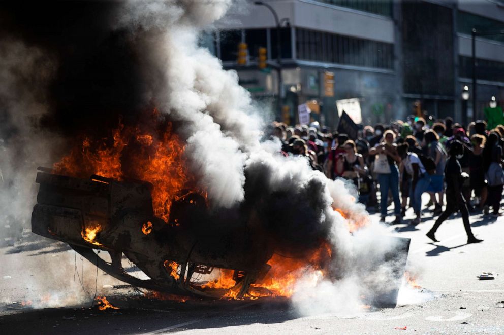 PHOTO: Smoke rises from a fire on a police cruiser in Center City during the "Justice for George Floyd" protest, May 30, 2020, in Philadelphia. 