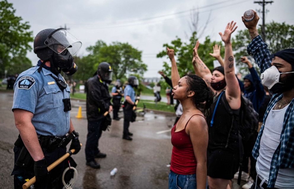 PHOTO: Protesters and police face each other during a rally for George Floyd in Minneapolis, May 26, 2020.
