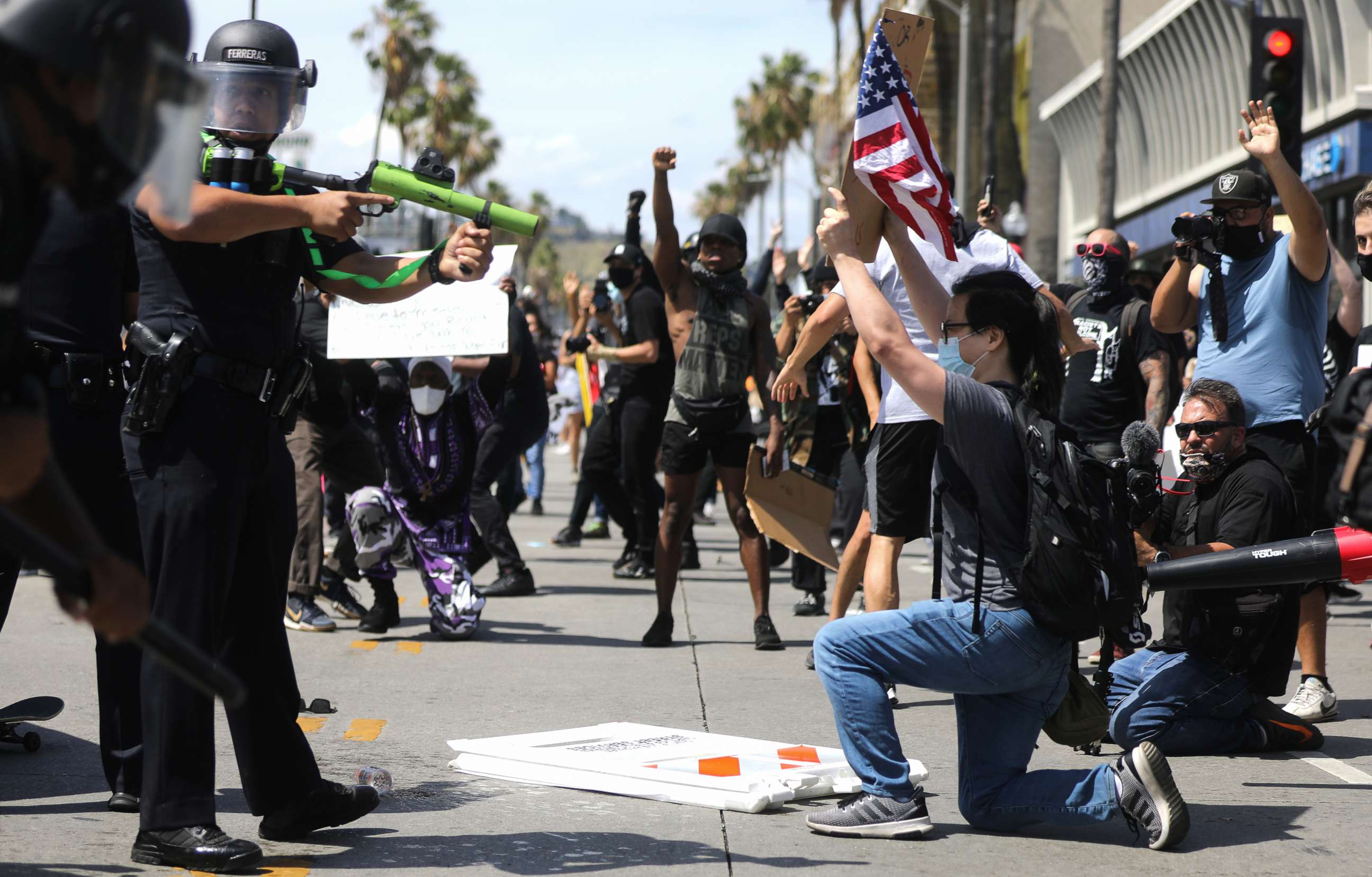 PHOTO: An LAPD officer aims a nonlethal weapon during a confrontation with protestors following the death of George Floyd, May 30, 2020, in Los Angeles.