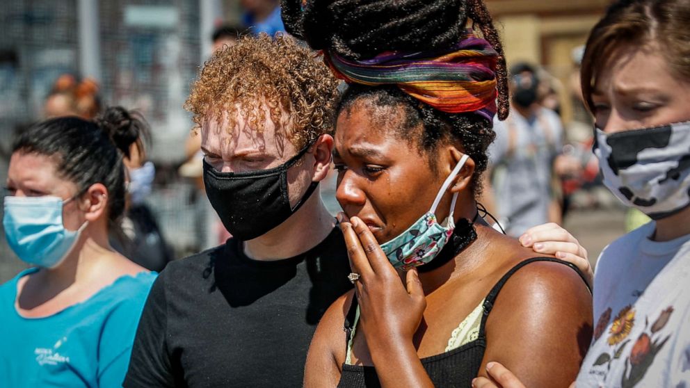 PHOTO: A mourner cries as she visits a makeshift memorial for George Floyd on the corner of Chicago Avenue and East 38th Street, May 31, 2020, in Minneapolis.