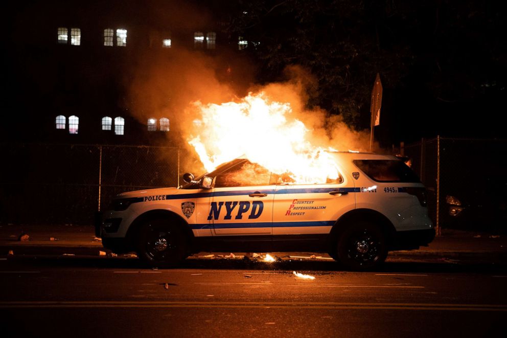 PHOTO: A NYPD police car is set on fire as protesters clash with police during a march against the death in Minneapolis police custody of George Floyd, in Brooklyn, New York, May 30, 2020.