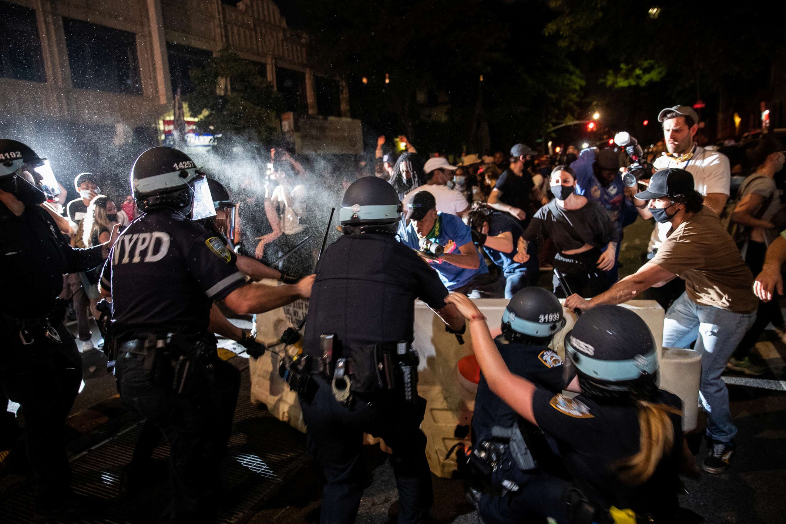 PHOTO: A police officer sprays protesters during a march against the death in Minneapolis police custody of George Floyd, in Brooklyn, New York, May 30, 2020.