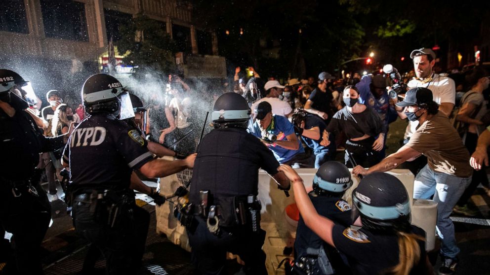 PHOTO: A police officer sprays protesters during a march against the death in Minneapolis police custody of George Floyd, in Brooklyn, New York, May 30, 2020.