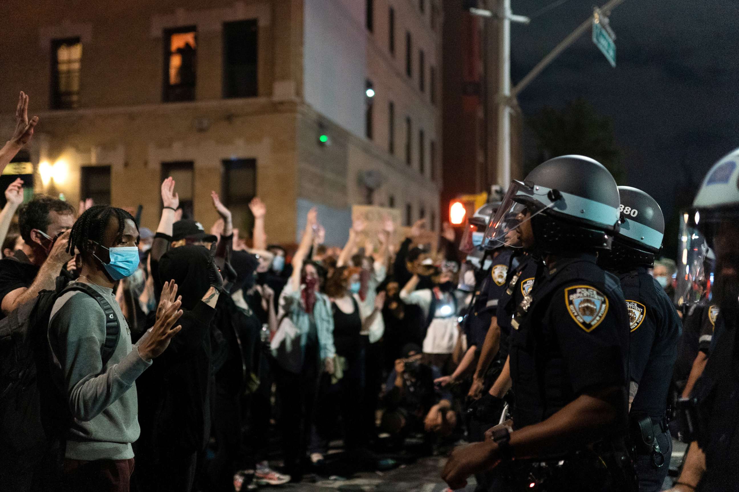 PHOTO: A protester raises his arms during a march against the death in Minneapolis police custody of George Floyd, in Brooklyn, New York, May 30, 2020.