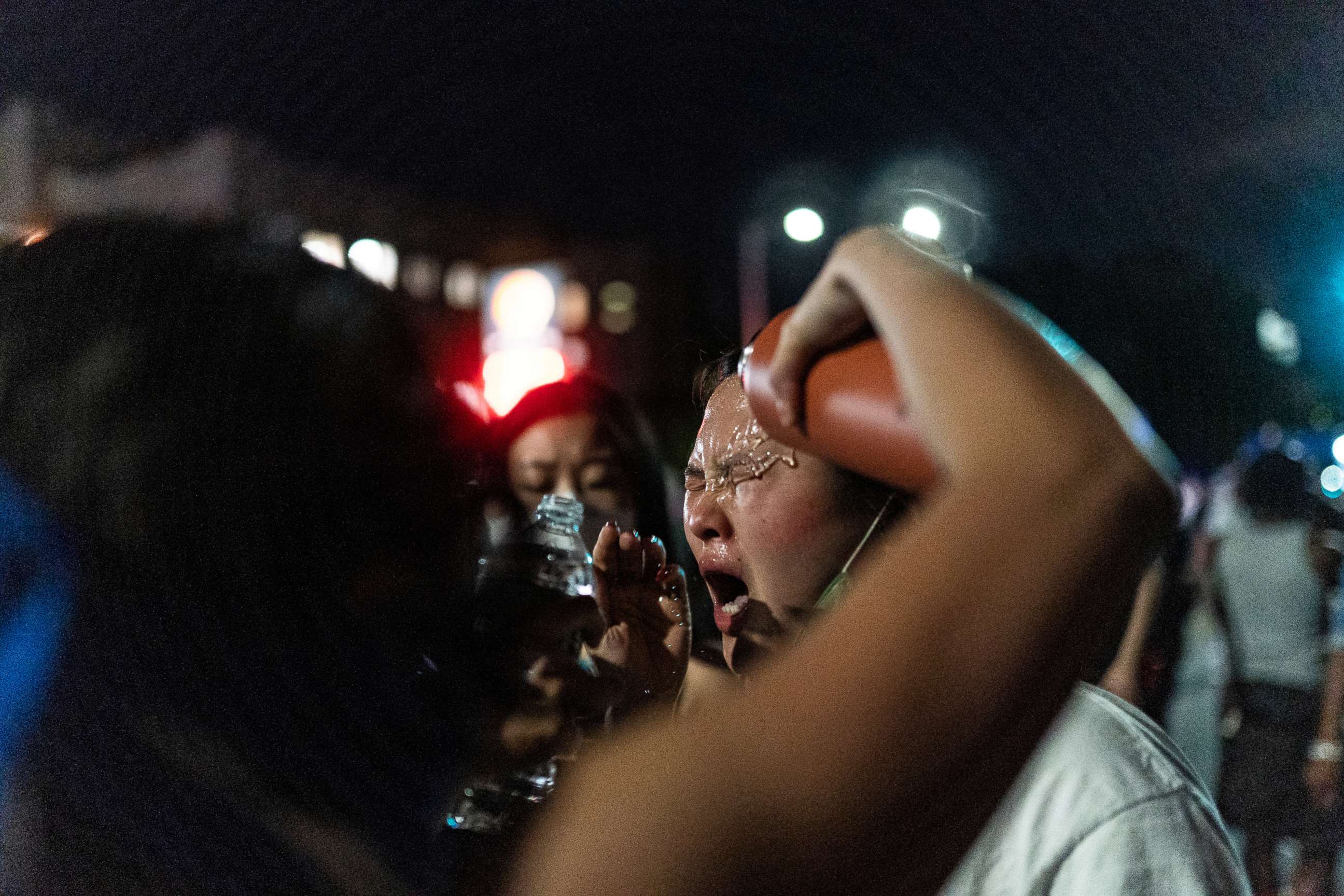 PHOTO: A protester is assisted after NYPD police officer sprayed protesters during clashes at a march against the death in Minneapolis police custody of George Floyd, in Brooklyn, New York, May 30, 2020.