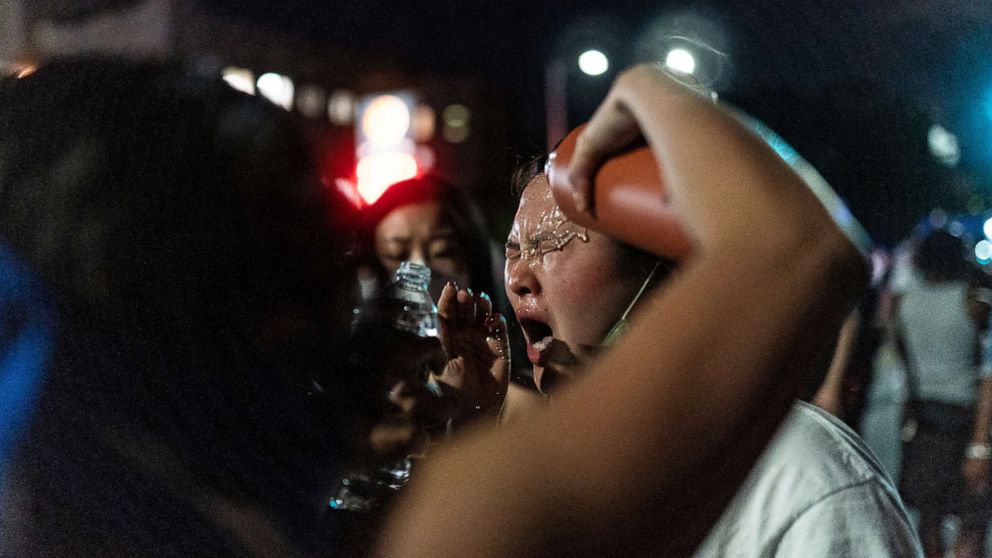 PHOTO: A protester is assisted after NYPD police officer sprayed protesters during clashes at a march against the death in Minneapolis police custody of George Floyd, in Brooklyn, New York, May 30, 2020.