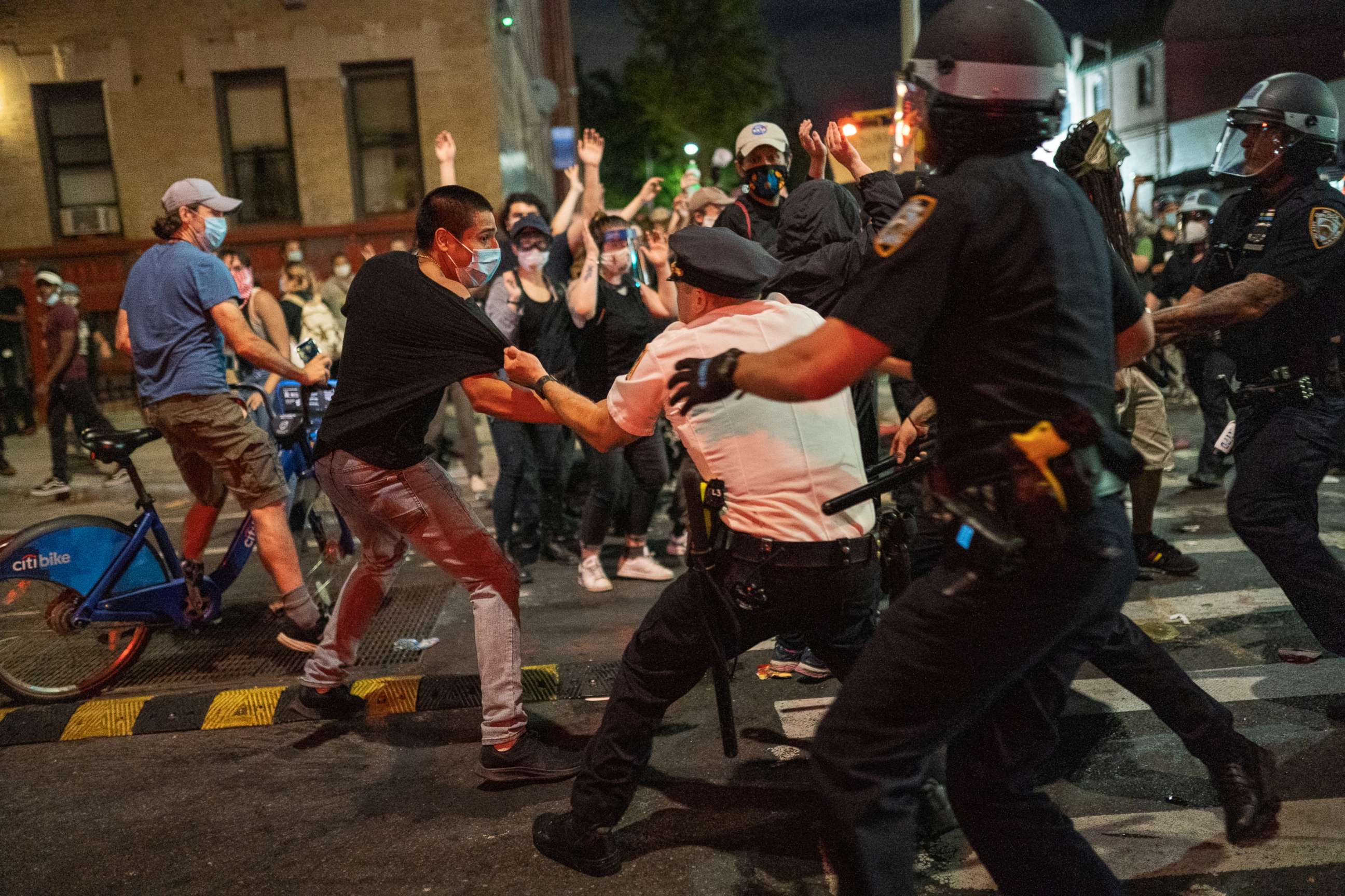 PHOTO: NYPD police officers detain a protester as they clash during a march against the death in Minneapolis police custody of George Floyd, in Brooklyn, New York, May 30, 2020.