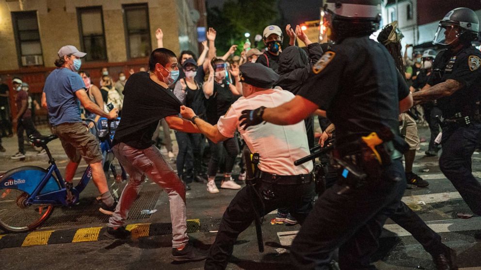 PHOTO: NYPD police officers detain a protester as they clash during a march against the death in Minneapolis police custody of George Floyd, in Brooklyn, New York, May 30, 2020.