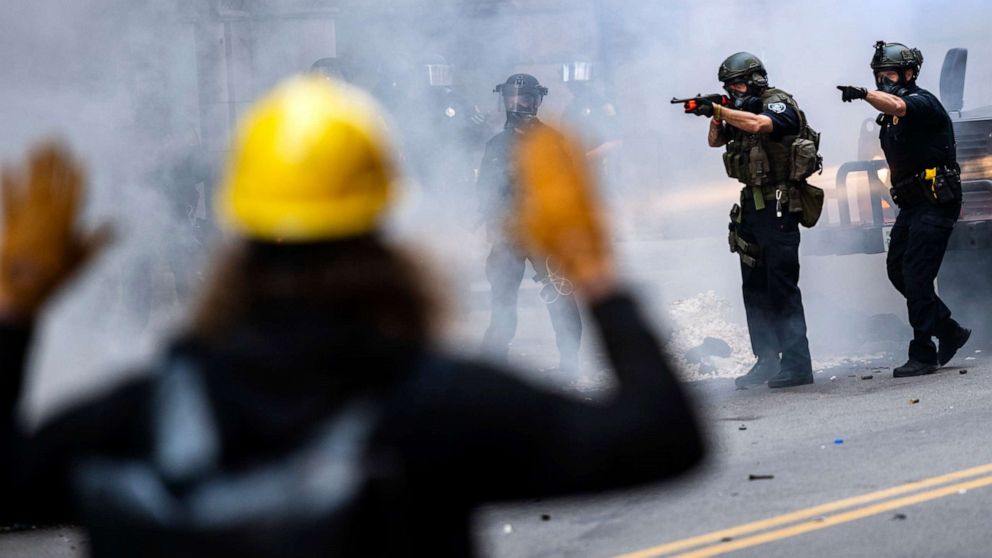 PHOTO: Police officers confront protesters during a demonstration demanding justice for George Floyd, May 30, 2020, on Sixth Street in Pittsburgh.