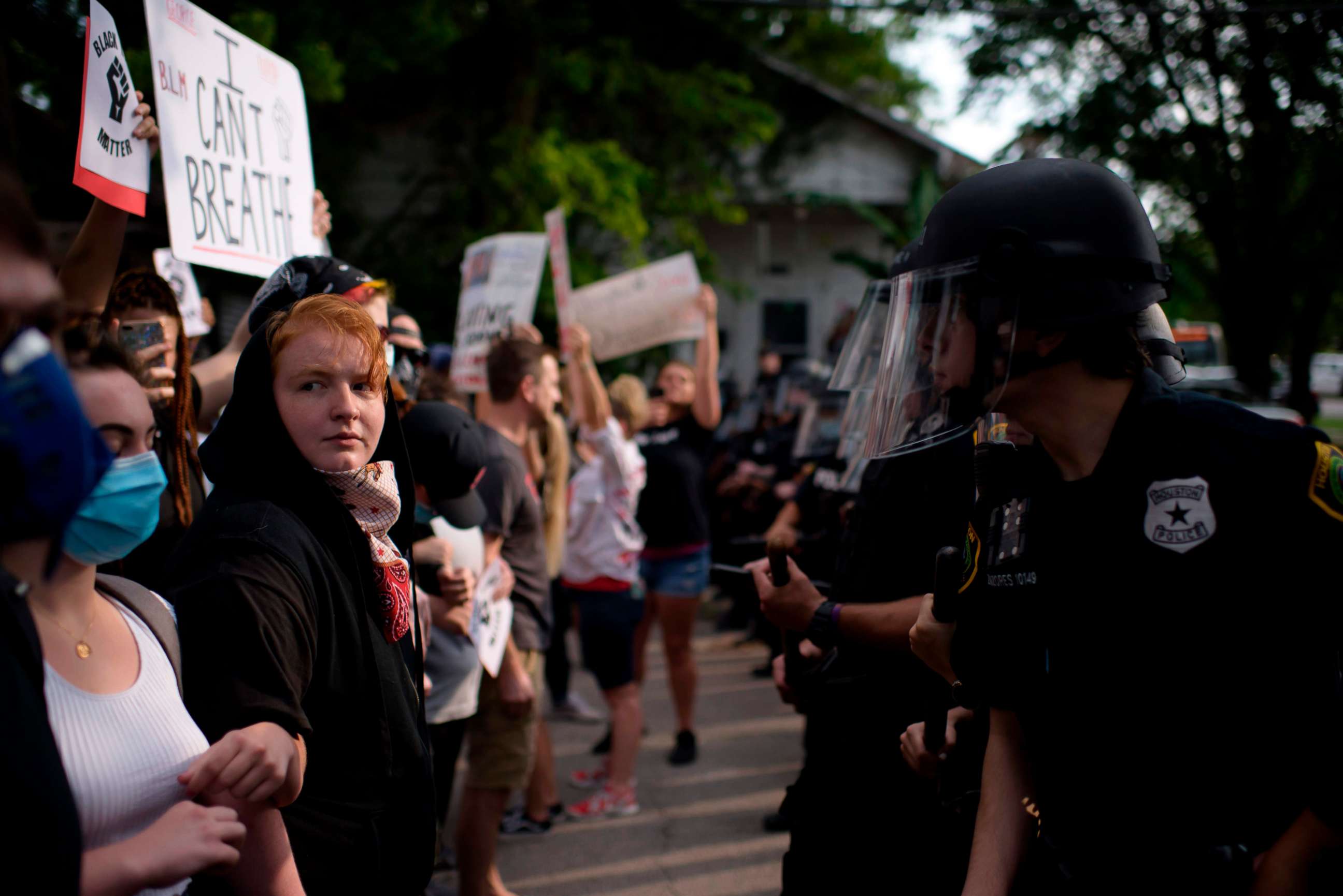 PHOTO: Participants face a row of police officers during a "Justice for George Floyd" event in Houston, Texas, May 30, 2020, after George Floyd, an unarmed black, died while being arrested and pinned to the ground by a Minneapolis police officer.