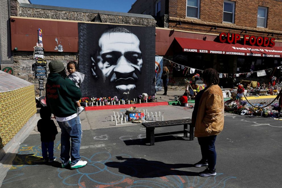 PHOTO: Visitors pay their respects at George Floyd Square while the fourth day of trial continues for Derek Chauvin, who is facing murder charges in the death of Floyd, in Minneapolis, April 1, 2021.