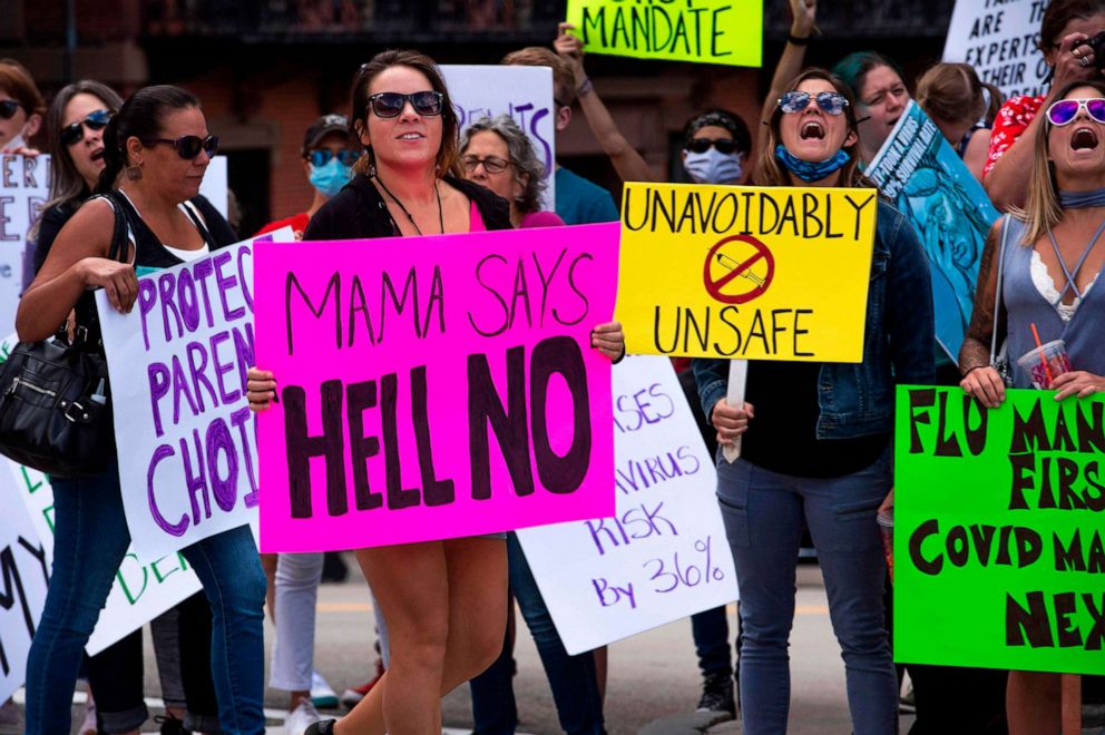 PHOTO: Hundreds of people of mixed political views, religions and cultures protest a mandate from the Massachusetts Governor requiring all children,age K-12, to receive an influenza (flu) vaccine/shot in Boston on August 30, 2020. 