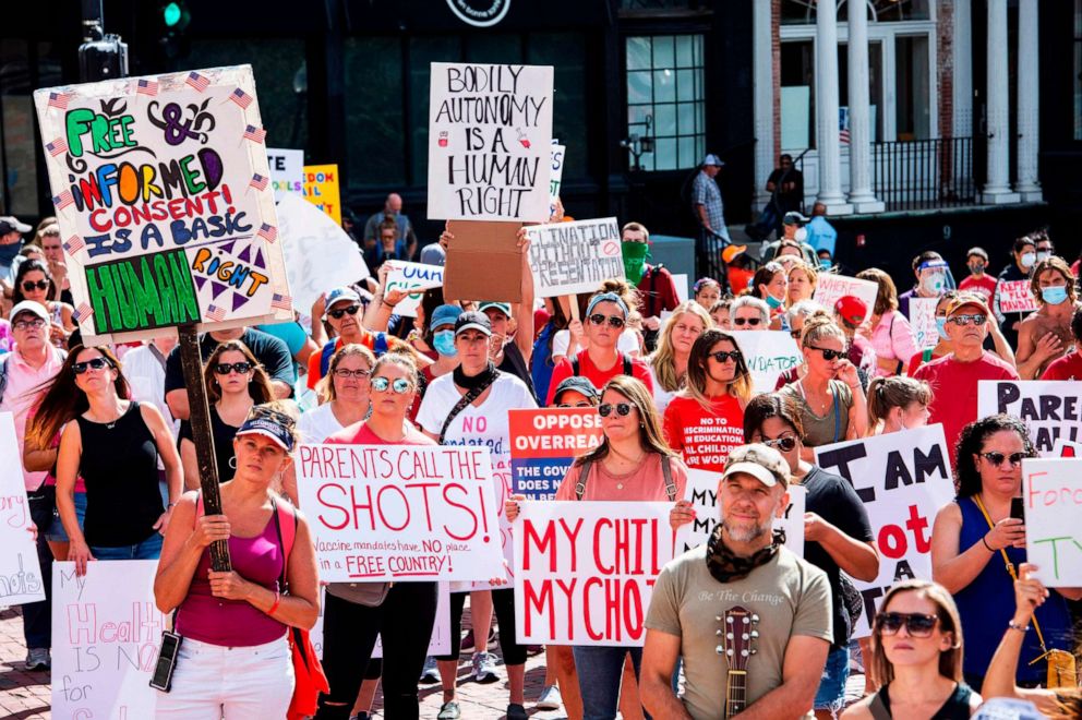 PHOTO: Hundreds of people of mixed political views, religions and cultures protest a mandate from the Massachusetts Governor requiring all children,age K-12, to receive an influenza (flu) vaccine/shot to attend school in Boston on August 30, 2020. 