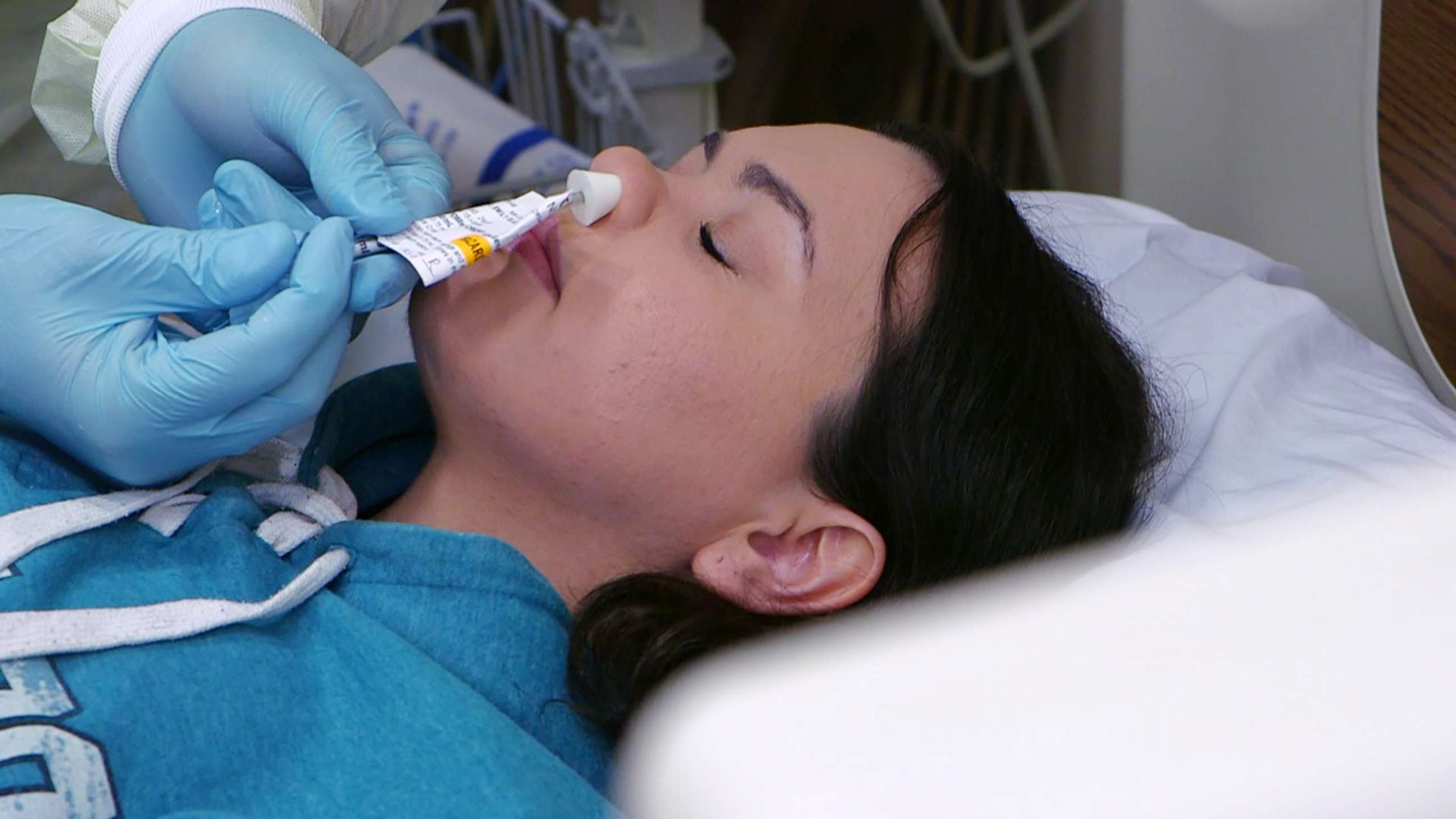 PHOTO: A participant in a study at the National Institute of Health receives a nasal spray containing the flu virus. 