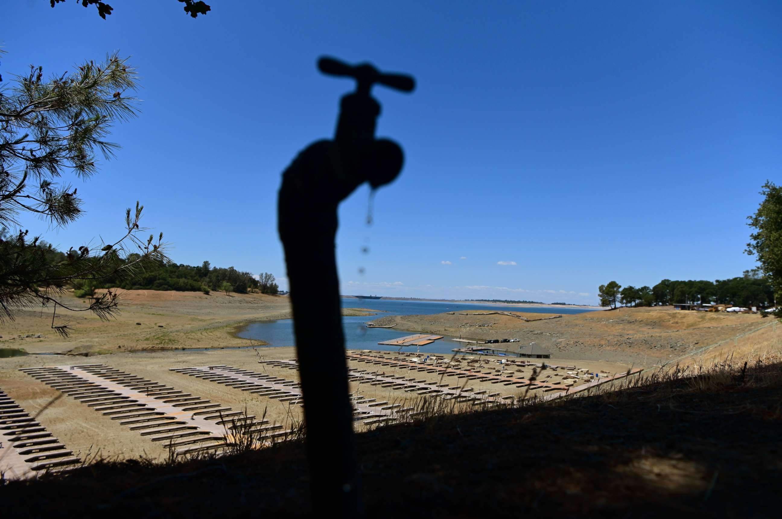 PHOTO: Water drips from a faucet near boat docks sitting on dry land at the Browns Ravine Cove area of drought-stricken Folsom Lake, currently at 37% of its normal capacity, in Folsom, Calif., May 22, 2021.