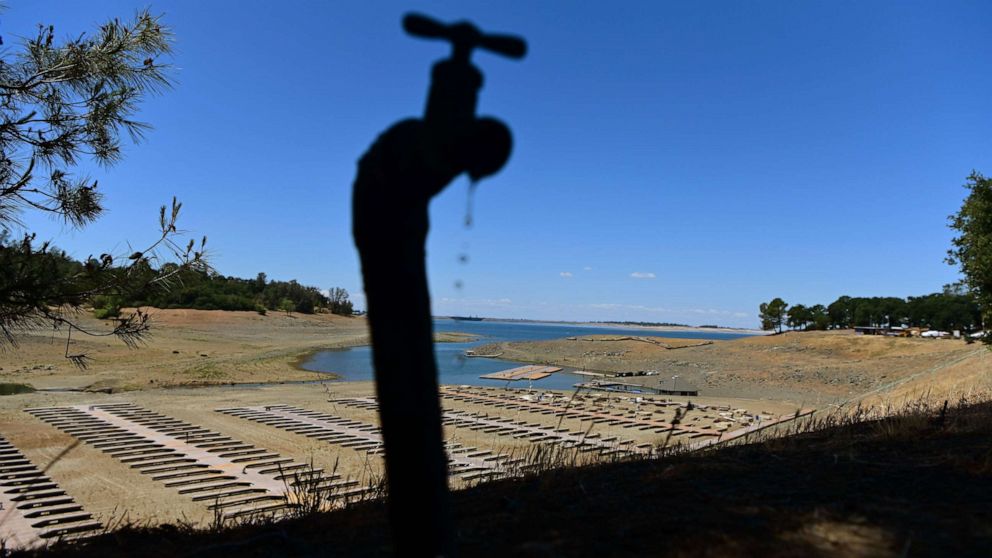 PHOTO: Water drips from a faucet near boat docks sitting on dry land at the Browns Ravine Cove area of drought-stricken Folsom Lake, currently at 37% of its normal capacity, in Folsom, Calif., May 22, 2021.
