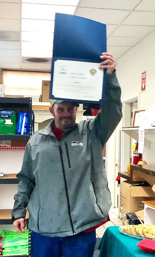 PHOTO: Kevin Booth holds his citation from Sumner Police Department at Sumner Community Food Bank, Nov., 29, 2018.