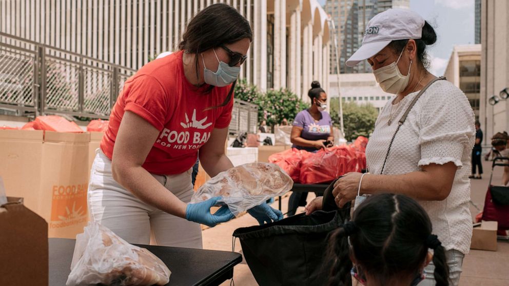 PHOTO: New Yorkers in need receive free produce, dry goods, and meat at a Food Bank For New York City distribution event at Lincoln Center on July 29, 2020, in New York City.