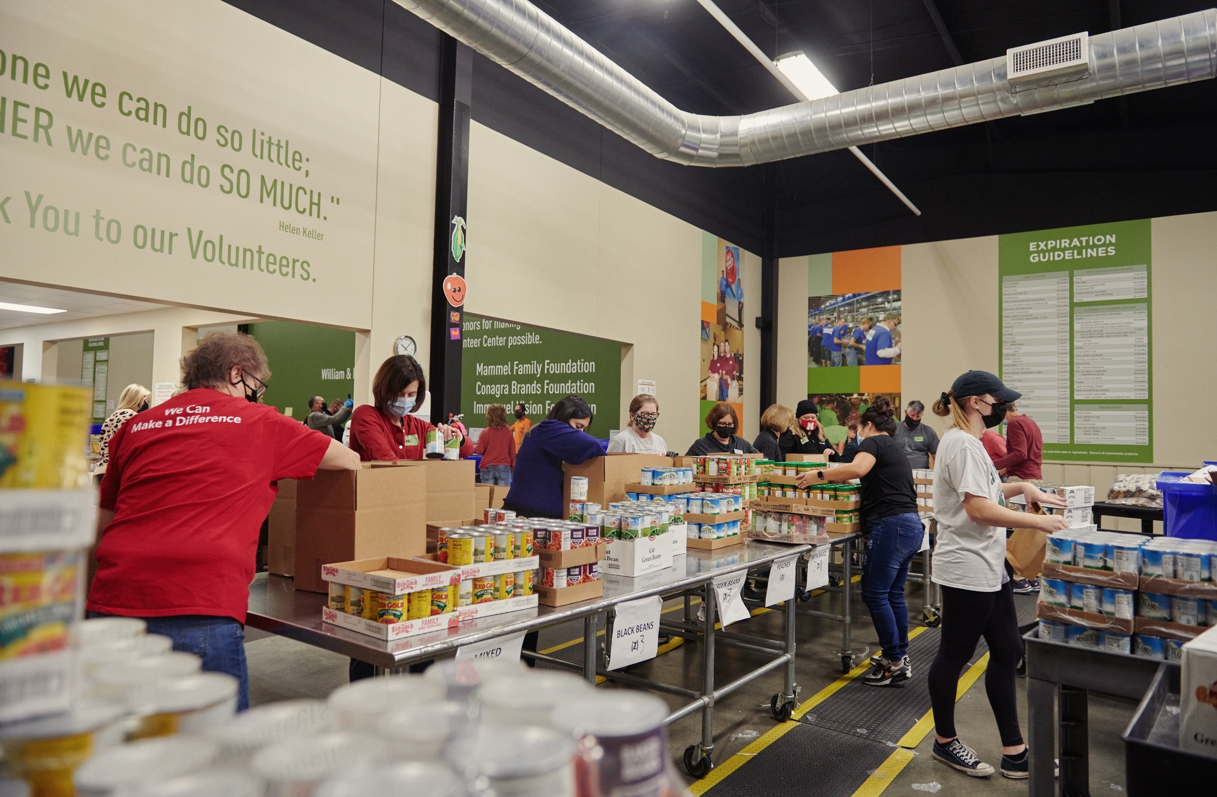 PHOTO: Volunteers fill boxes at the Food Bank for the Heartland distribution warehouse in Omaha, Neb., Dec. 8, 2021. 